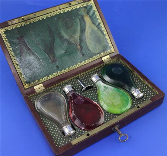 A 19th century French mahogany cased set of four silver mounted glass scent bottles and perfume funnel,